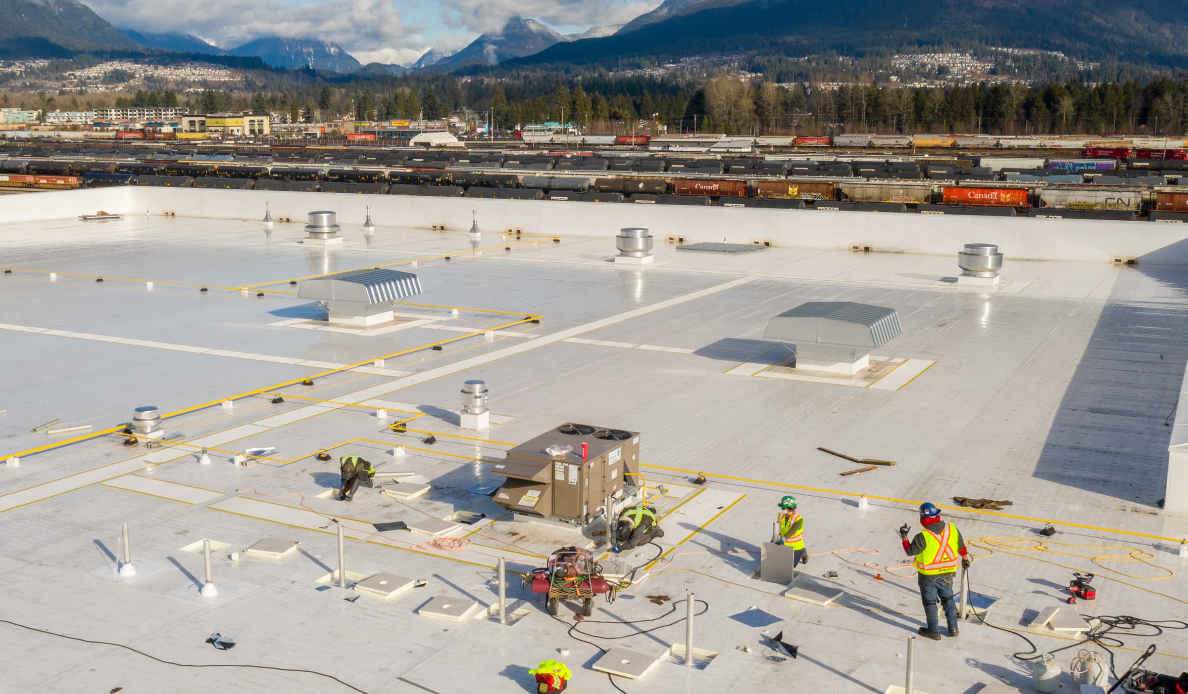 Raven Roofing crew at work on a commercial roof